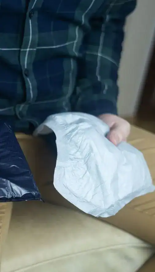 Image of man holding incontinence pads as part of overactive bladder treatment Norwich