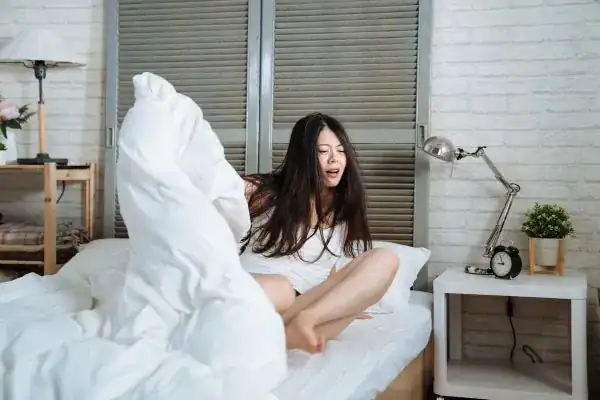 Image of woman getting up because of nighttime leaks Norwich